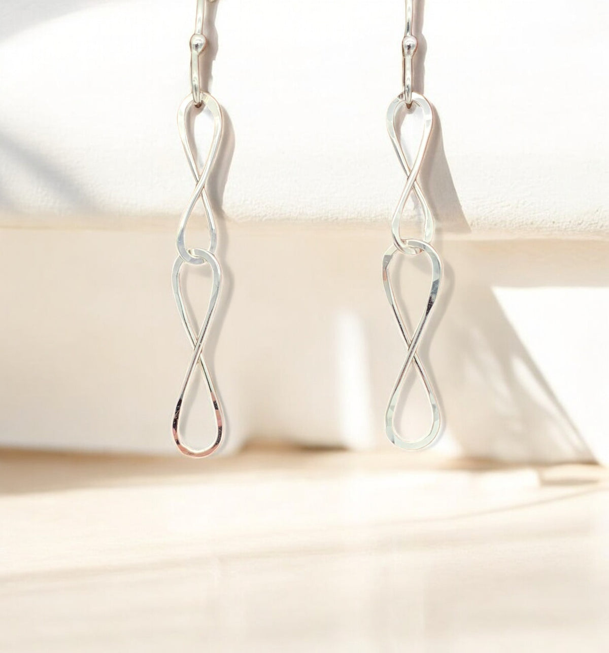 Double Infinity Dangles SS by Sausalito Precious Metals Inc.