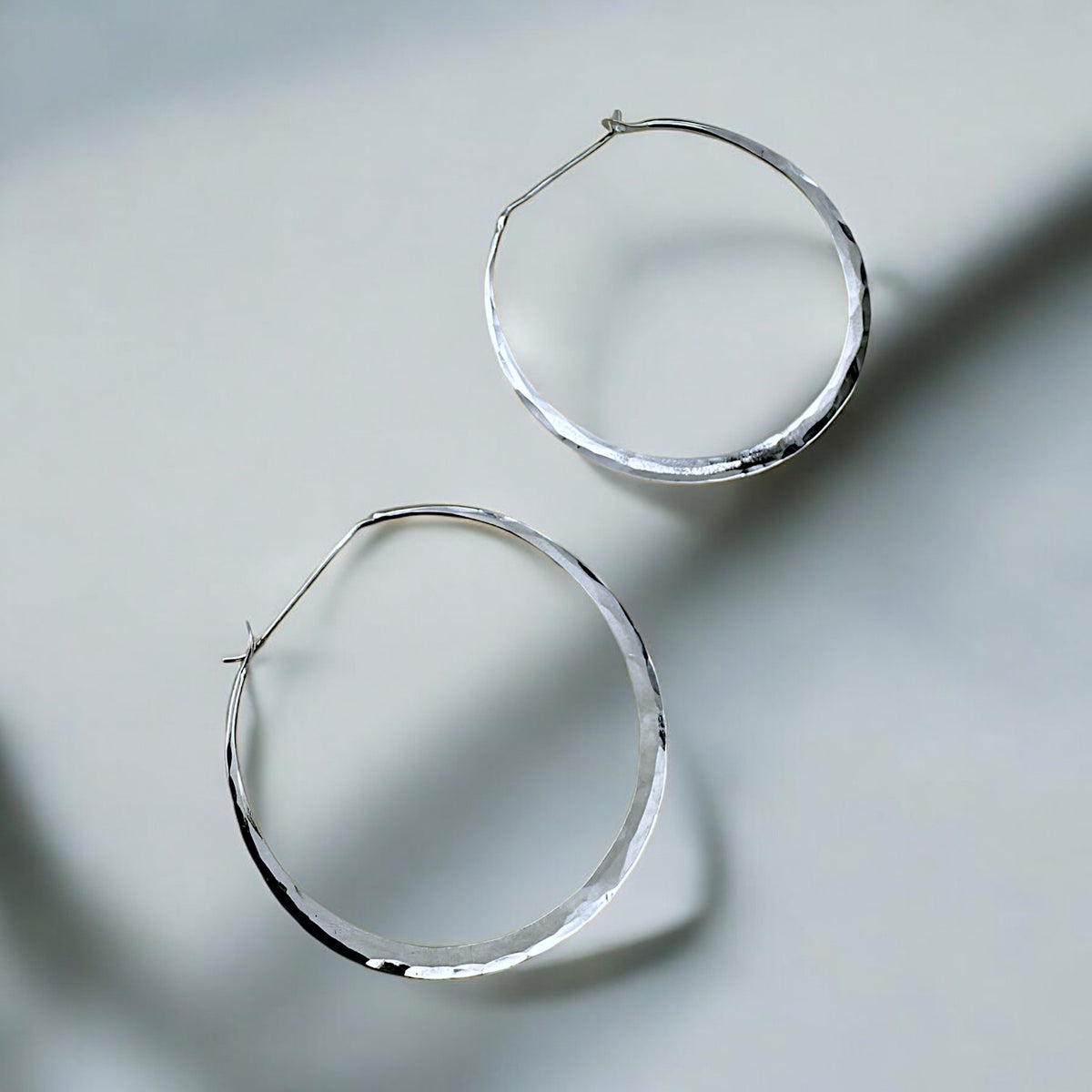 Hammered & Forged Hoop Style Earrings by Sausalito Precious Metals Inc.